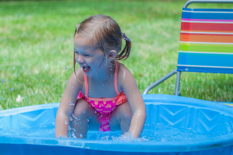 Little Girl Playing in a Kiddie Pool