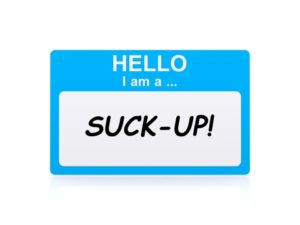 A name sticker that reads, "Hello, I am a... SUCK-UP!"