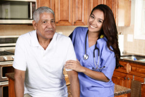 female home health care aide assisting an elderly male client