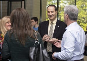 Businessman schmoozing colleagues at a social gathering