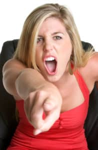 Woman screaming and pointing an accusing finger at you